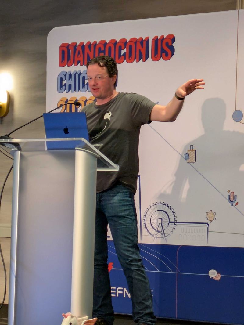 Tim Allen giving his lightning talk on the main stage at DjangoCon 2026.