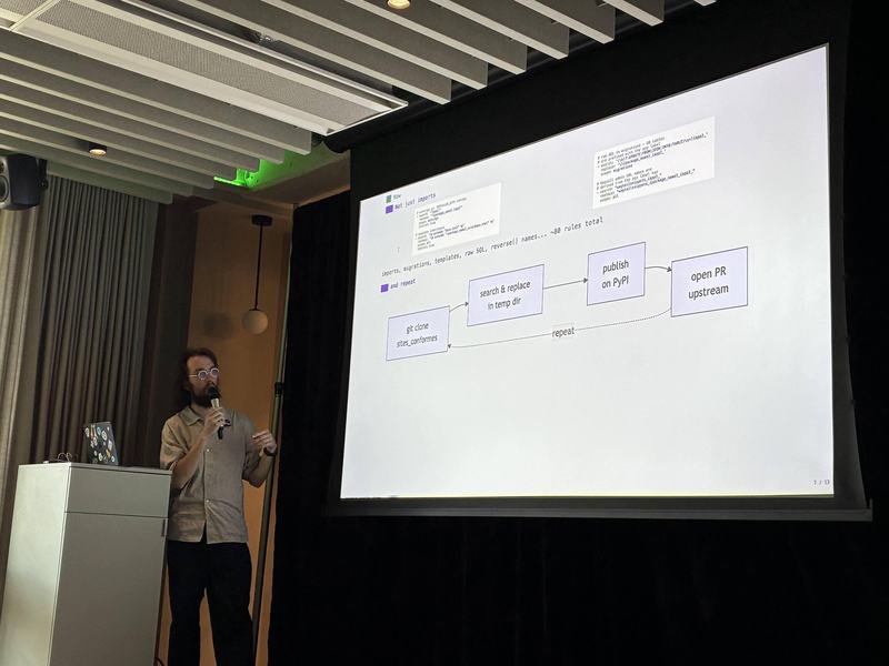 Presenter explaining an import workflow diagram with Git, PyPI, and pull request steps