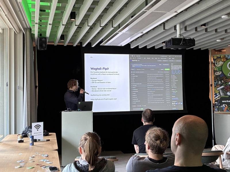 Speaker explaining code and command output on a projected slide during a technical talk