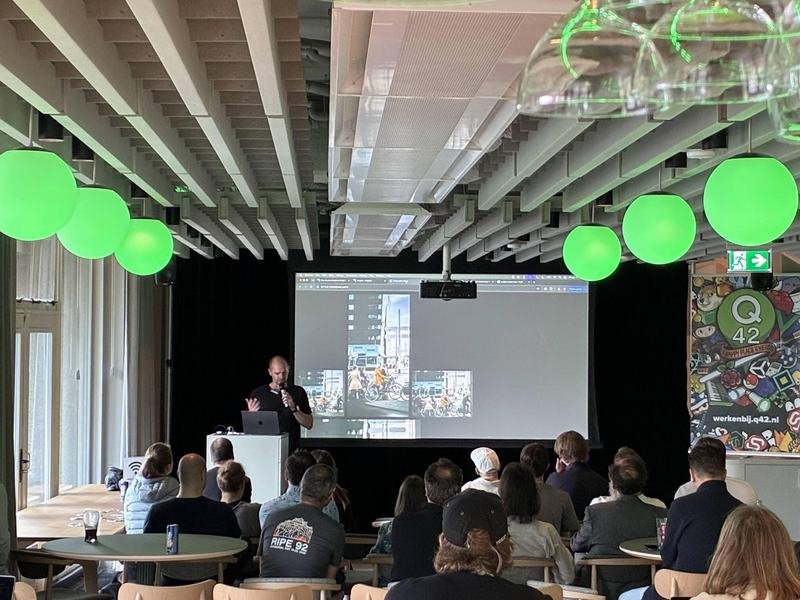 Speaker showing image editing previews on screen during a Wagtail Space presentation