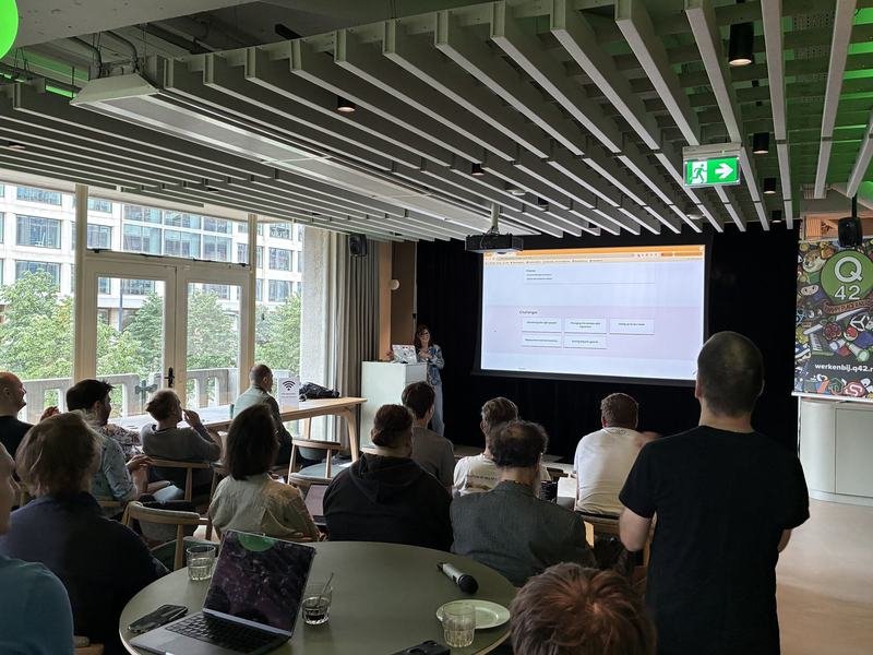 Wide view of attendees watching a Wagtail conference talk in the Q42 event room during the morning