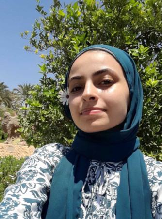A headshot of Raghad Dahi smiling