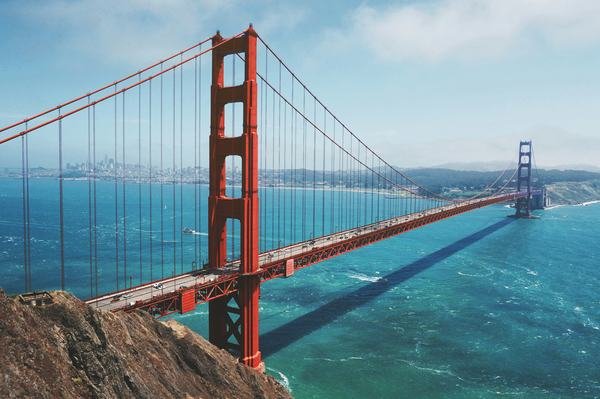 A view from the north side of the Golden Gate bridge with the city of San Francisco in the background. Photo by Anthony Choren on Unsplash, available at https://unsplash.com/@tony_cm__